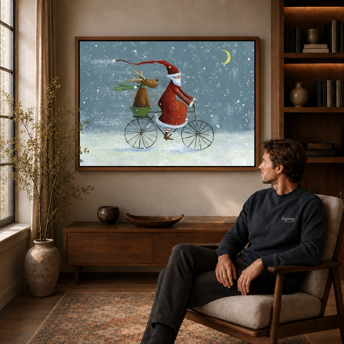 Walnut framed santa bicycle ride artwork above a seated man in a wood furnished living room.