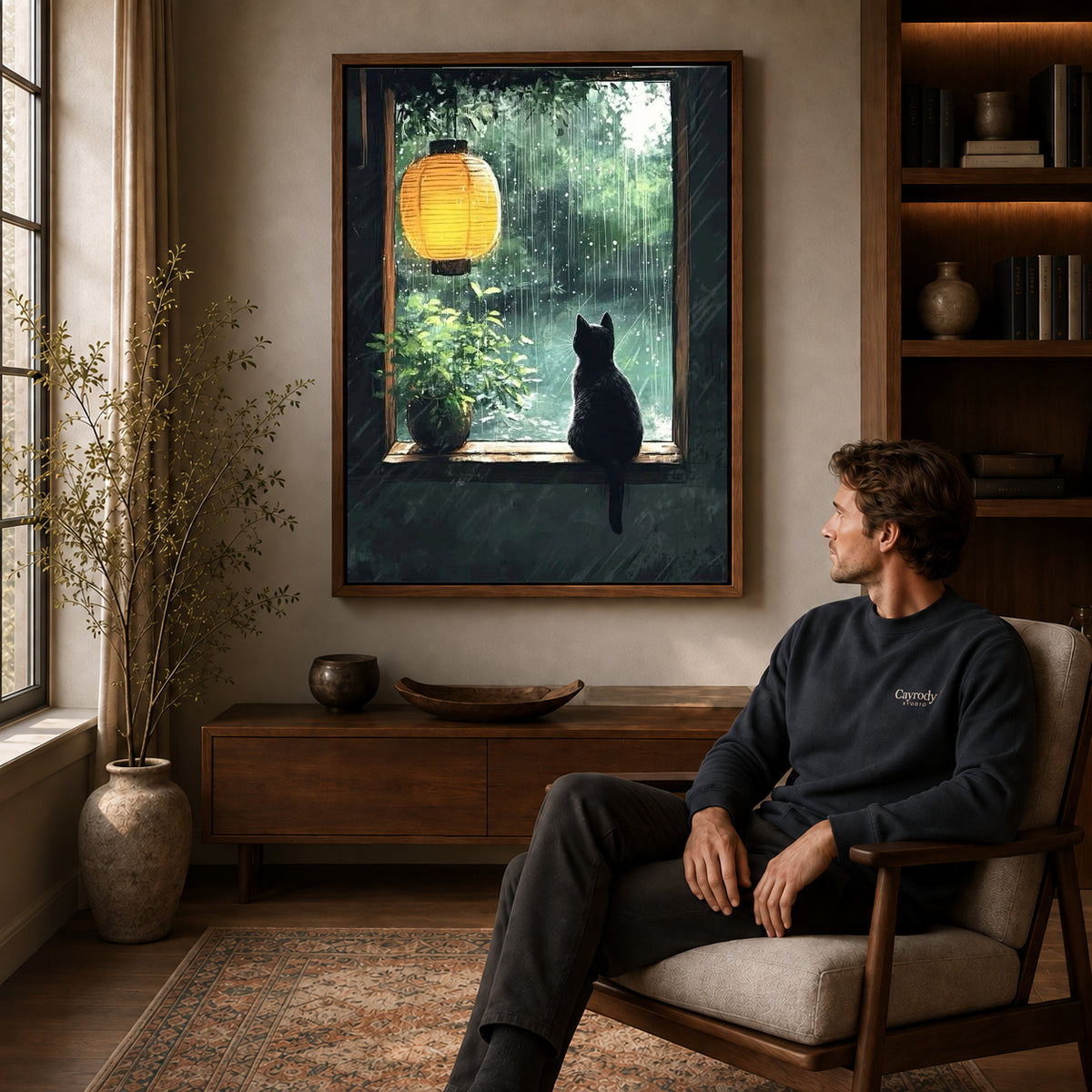 Walnut framed rainy window cat canvas art displayed above a seated man in a wood furnished living room.