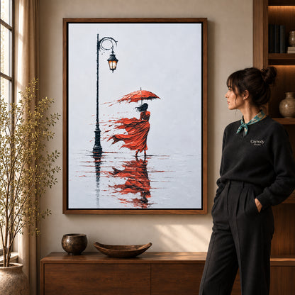 Windy Red Umbrella artwork in a walnut frame beside a standing woman in a warm room.