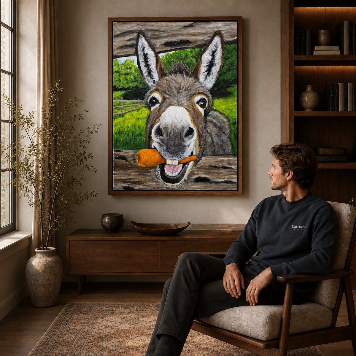 Walnut framed carrot loving donkey artwork above a seated man in a wood furnished living room.