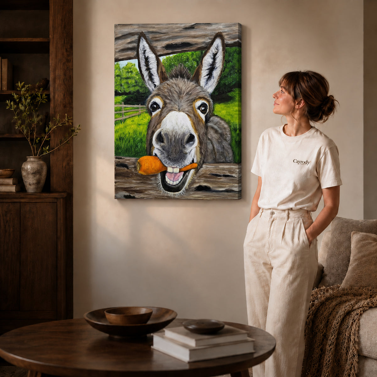 Gallery wrapped carrot loving donkey artwork with shaded canvas edges beside a woman wearing cream clothing.