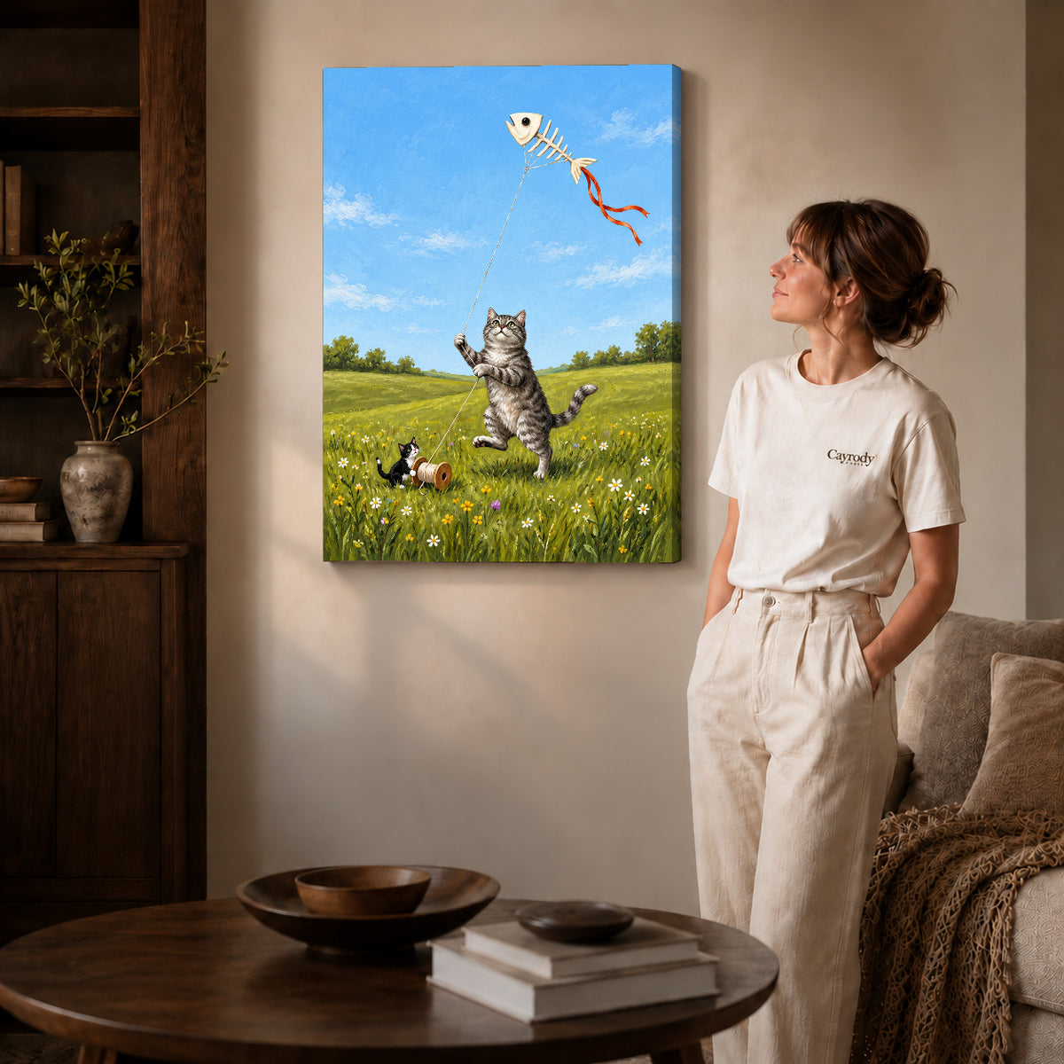 Gallery wrapped kitten kite friends artwork with shaded canvas edges beside a woman wearing cream clothing.