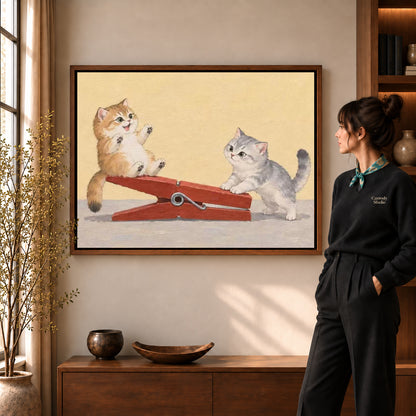 Clothespin Kitten Friends artwork in a walnut frame beside a standing woman in a warm room.