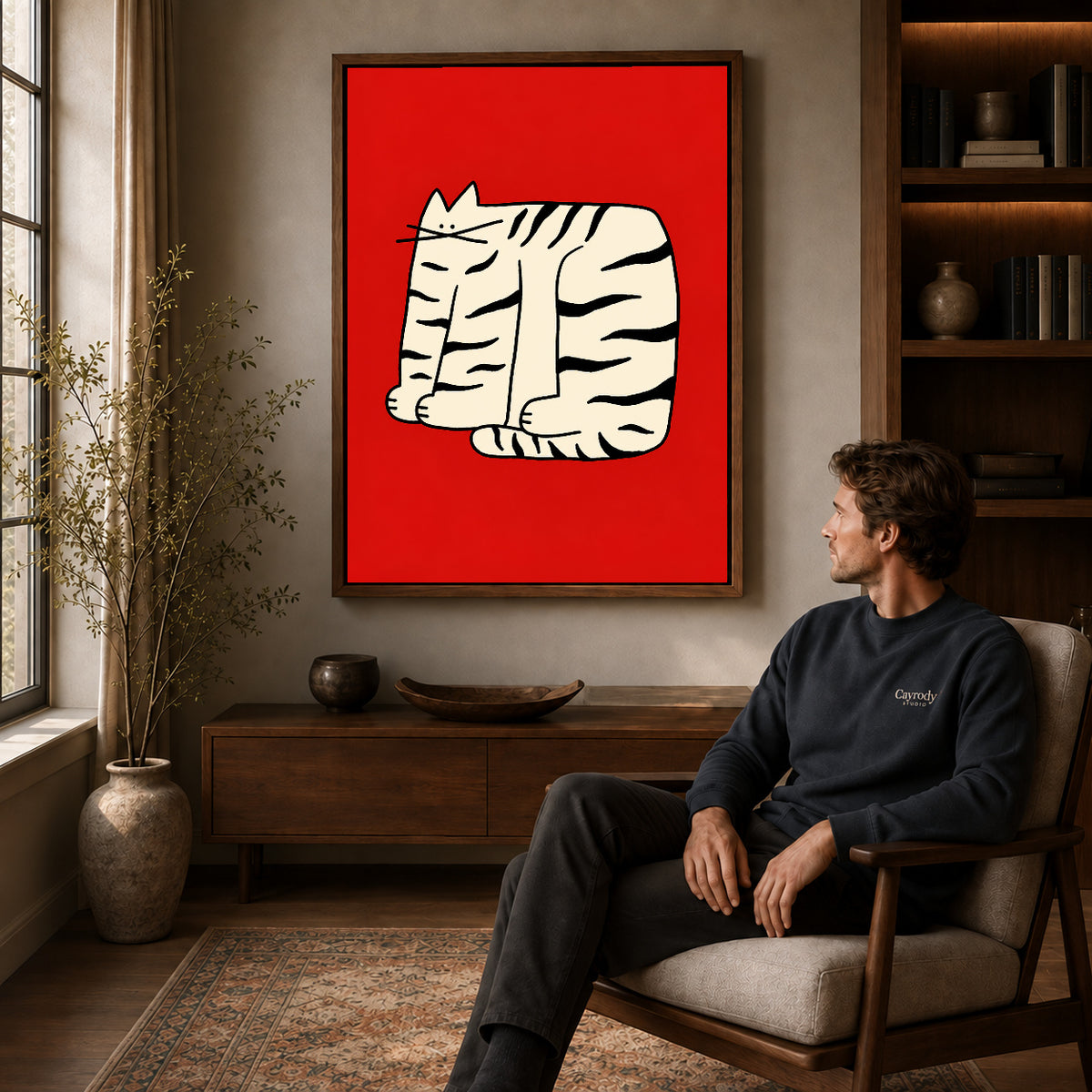 Walnut framed bold striped cat artwork above a seated man in a wood furnished living room.