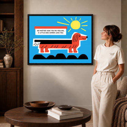 Black framed little dog love artwork beside a woman in a warm neutral living room.