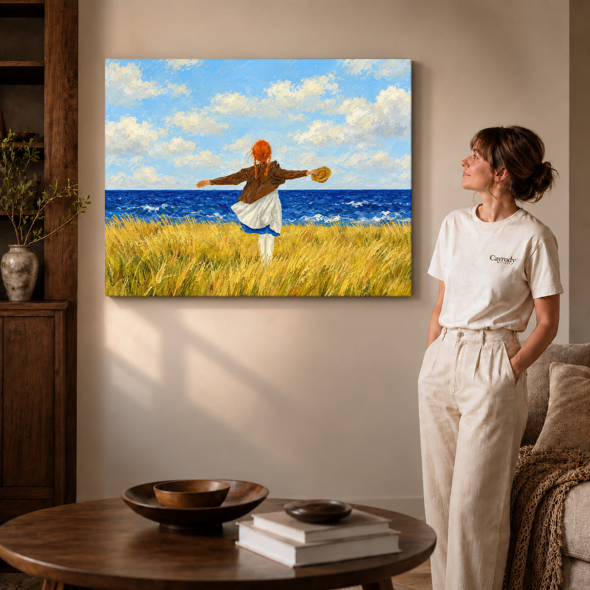 Gallery wrapped seaside freedom artwork with shaded canvas edges beside a woman wearing cream clothing.
