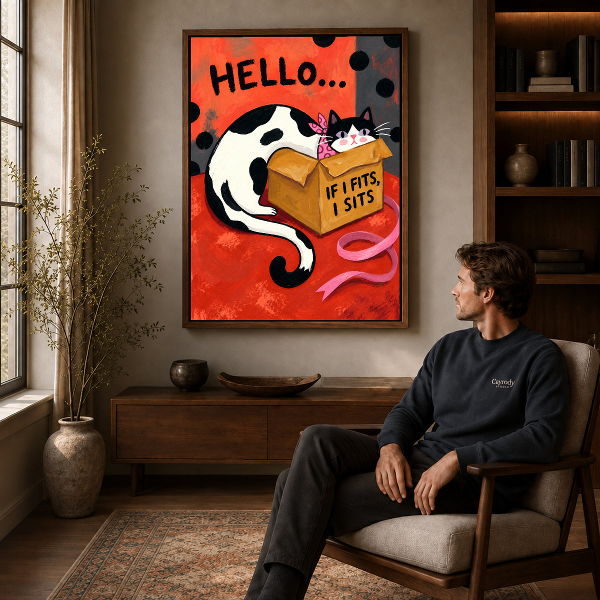 Walnut framed cozy cardboard cat artwork above a seated man in a wood furnished living room.