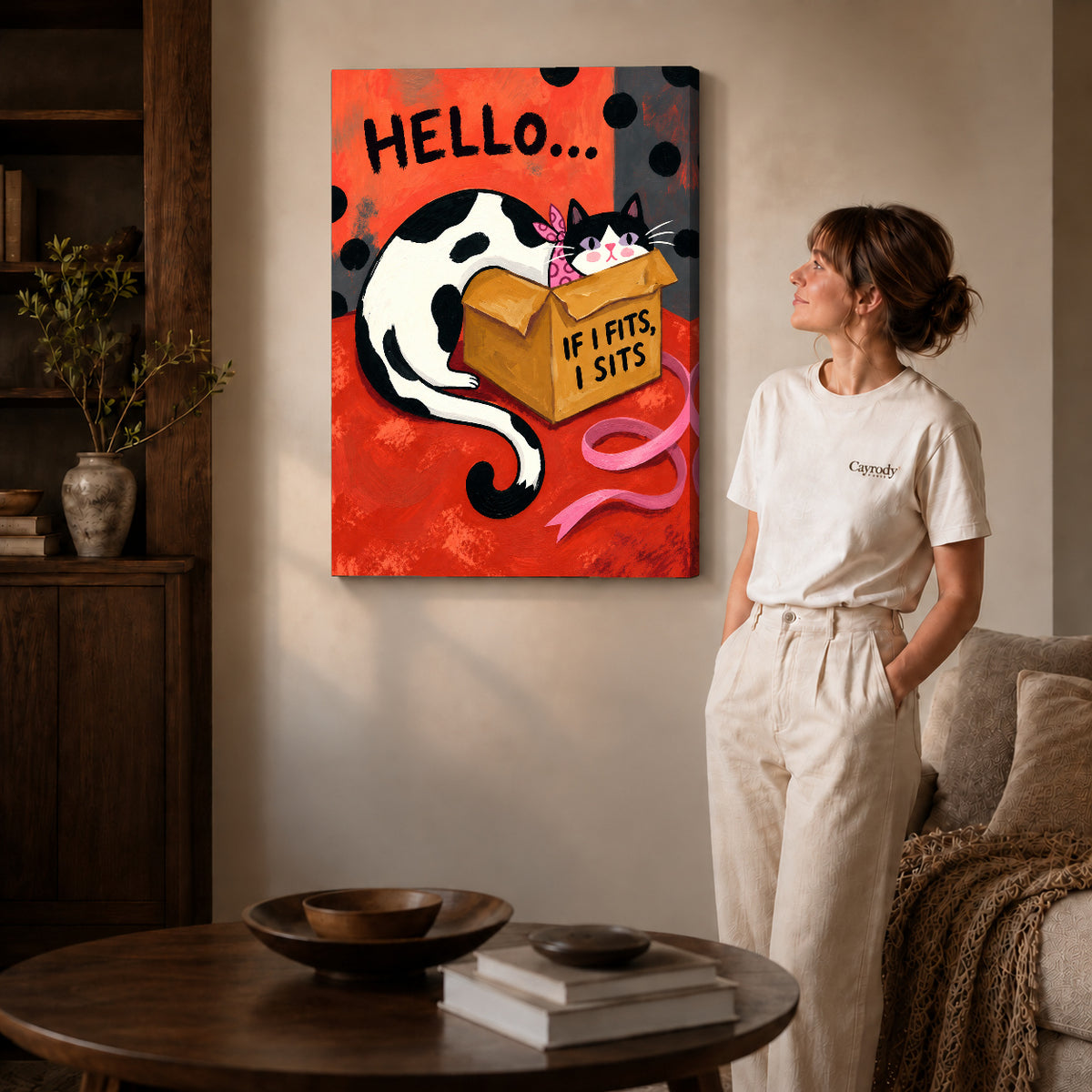 Gallery wrapped cozy cardboard cat artwork with shaded canvas edges beside a woman wearing cream clothing.