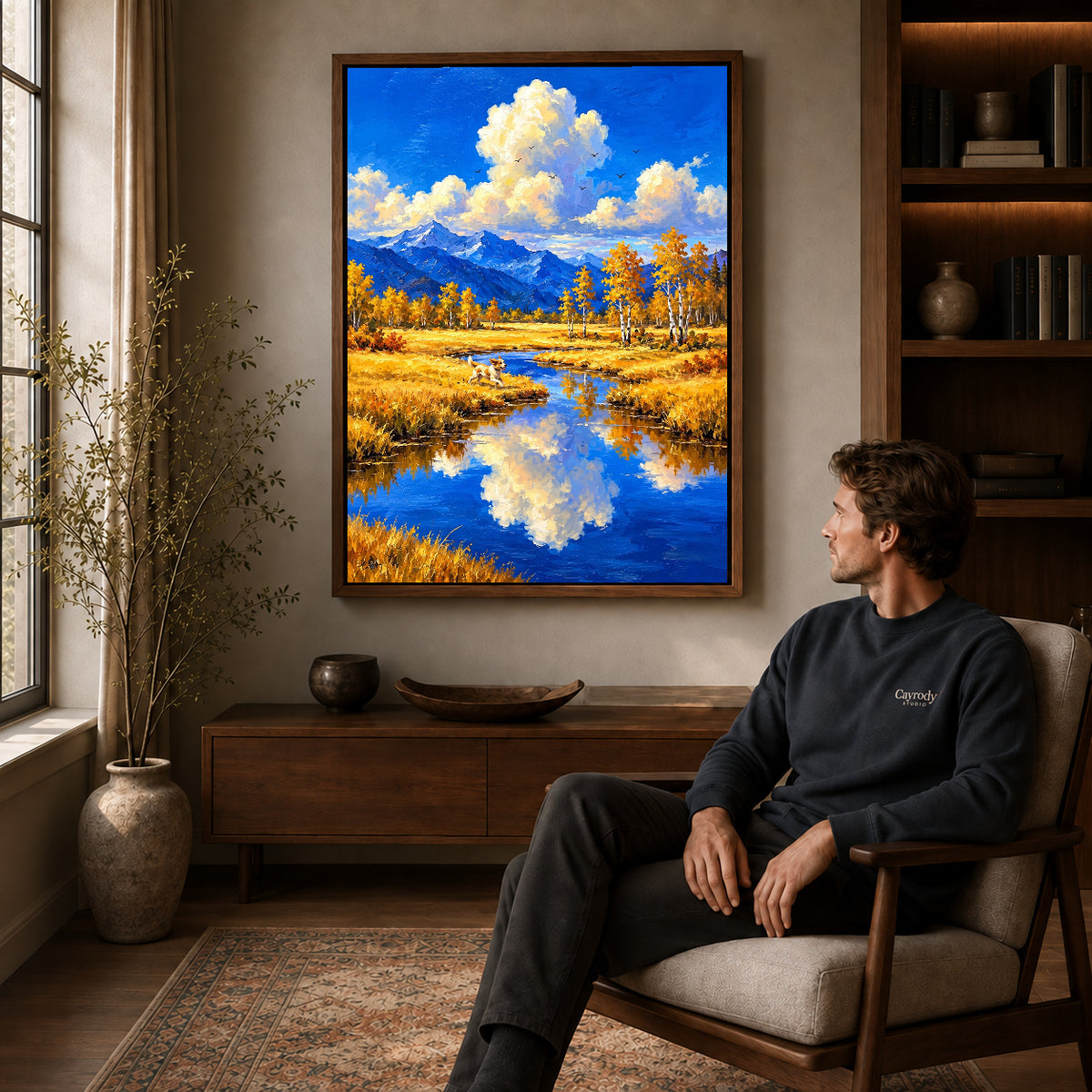 Walnut framed autumn river dog artwork above a seated man in a wood furnished living room.