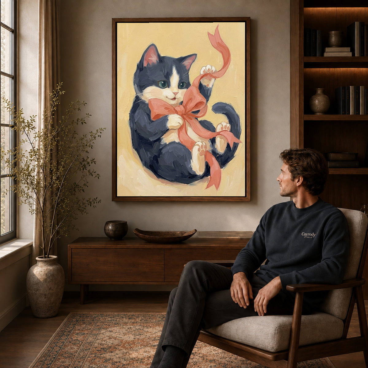 Walnut framed ribbon playing kitten artwork above a seated man in a wood furnished living room.
