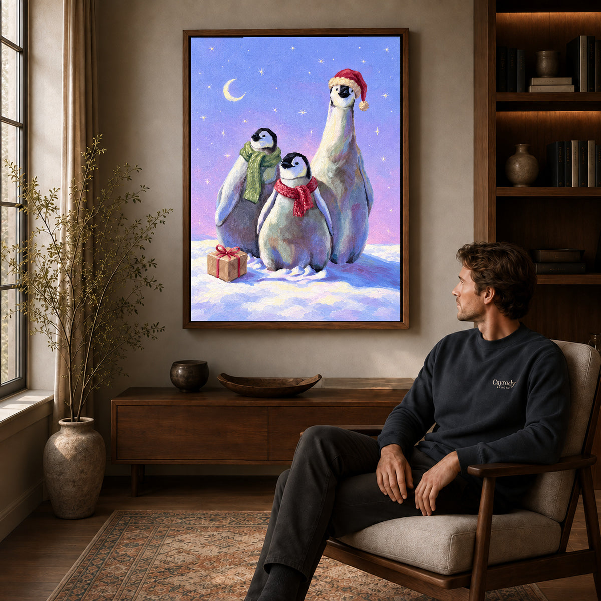 Walnut framed christmas penguin trio artwork above a seated man in a wood furnished living room.