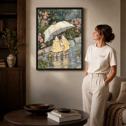 Black framed raincoat kitten friends artwork beside a woman in a warm neutral living room.