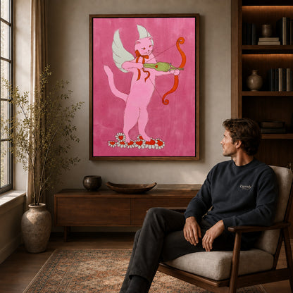 Walnut framed cupid archer cat artwork above a seated man in a wood furnished living room.