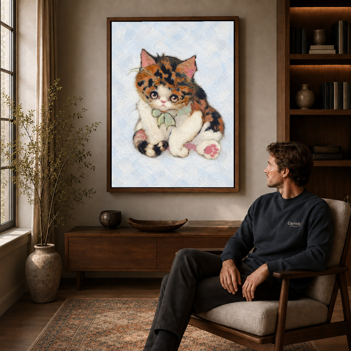 Walnut framed calico bow kitten artwork above a seated man in a wood furnished living room.