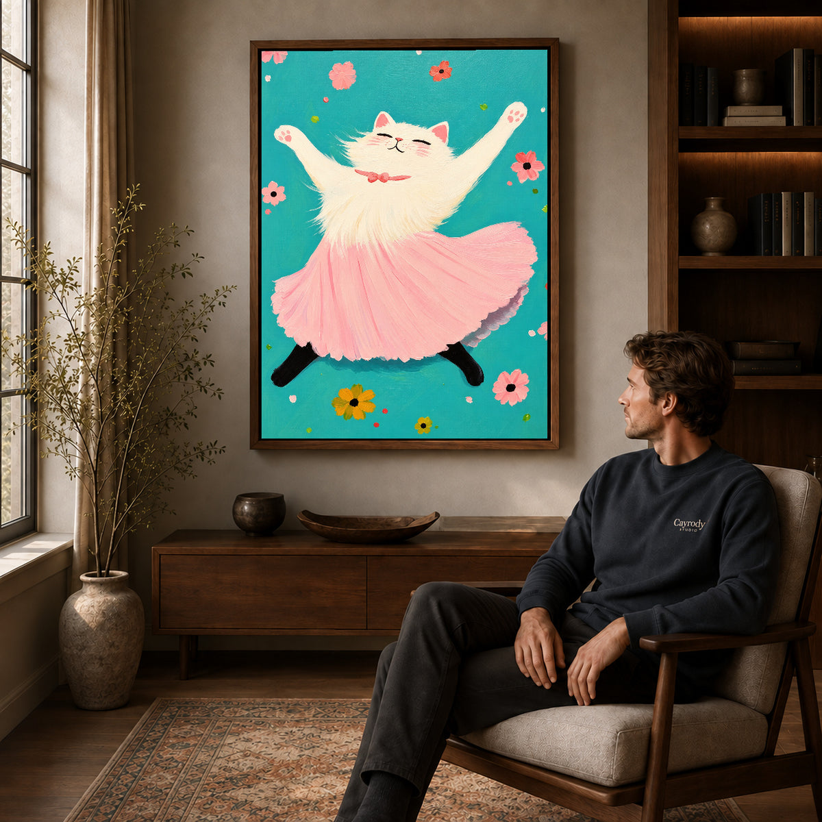Walnut framed joyful ballet cat artwork above a seated man in a wood furnished living room.