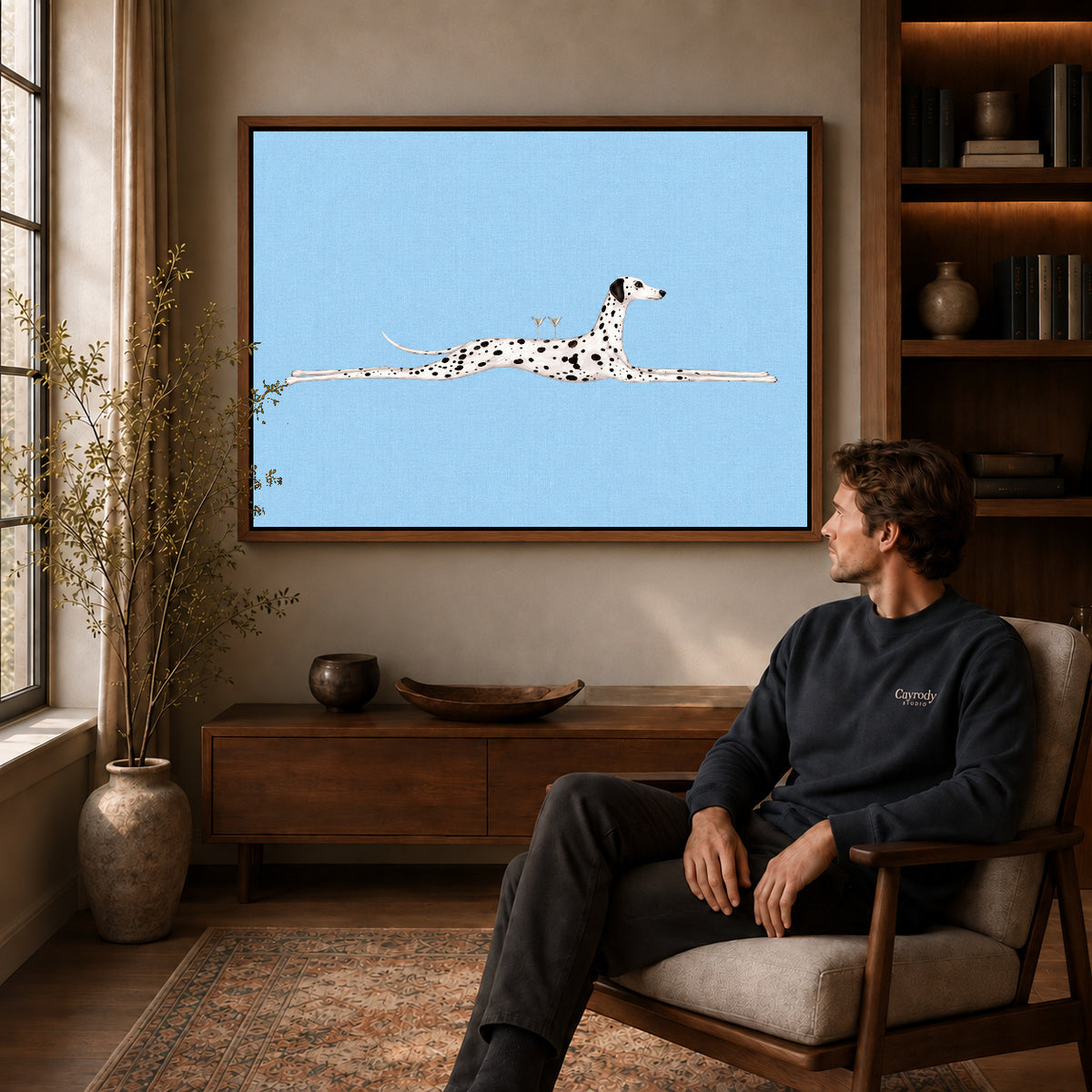 Walnut framed long dalmatian lounge artwork above a seated man in a wood furnished living room.
