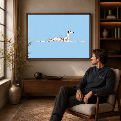 Walnut framed long dalmatian lounge artwork above a seated man in a wood furnished living room.