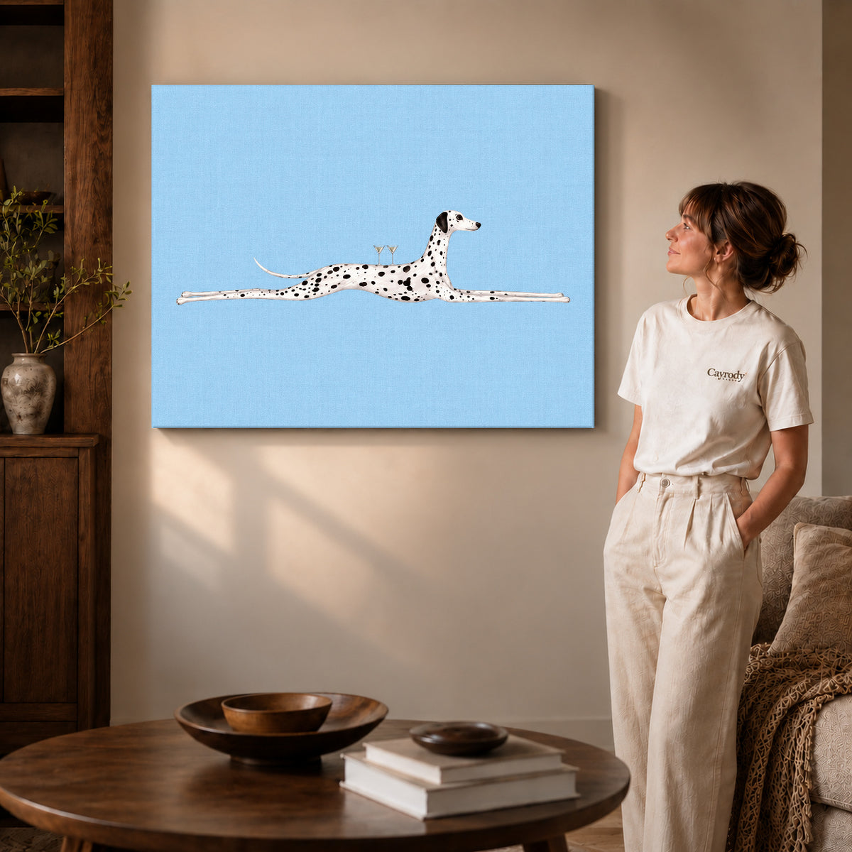 Gallery wrapped long dalmatian lounge artwork with shaded canvas edges beside a woman wearing cream clothing.