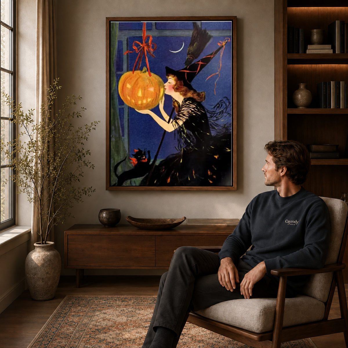 Walnut framed vintage witch canvas art displayed above a seated man in a wood furnished living room.