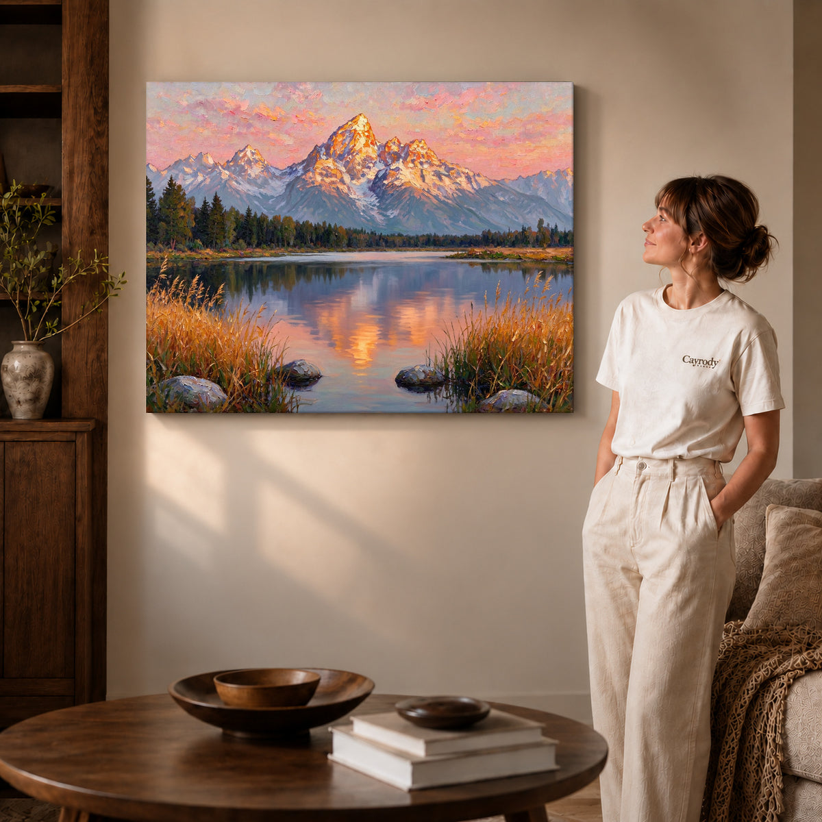 Gallery wrapped golden mountain reflection artwork with shaded canvas edges beside a woman wearing cream clothing.