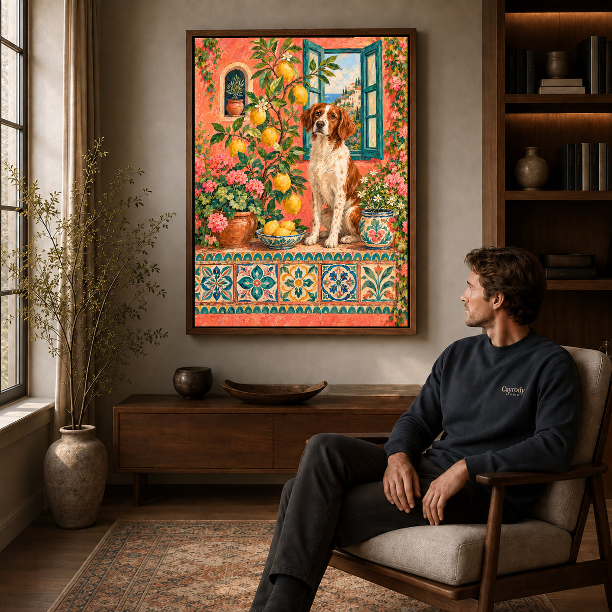 Walnut framed lemon garden spaniel artwork above a seated man in a wood furnished living room.