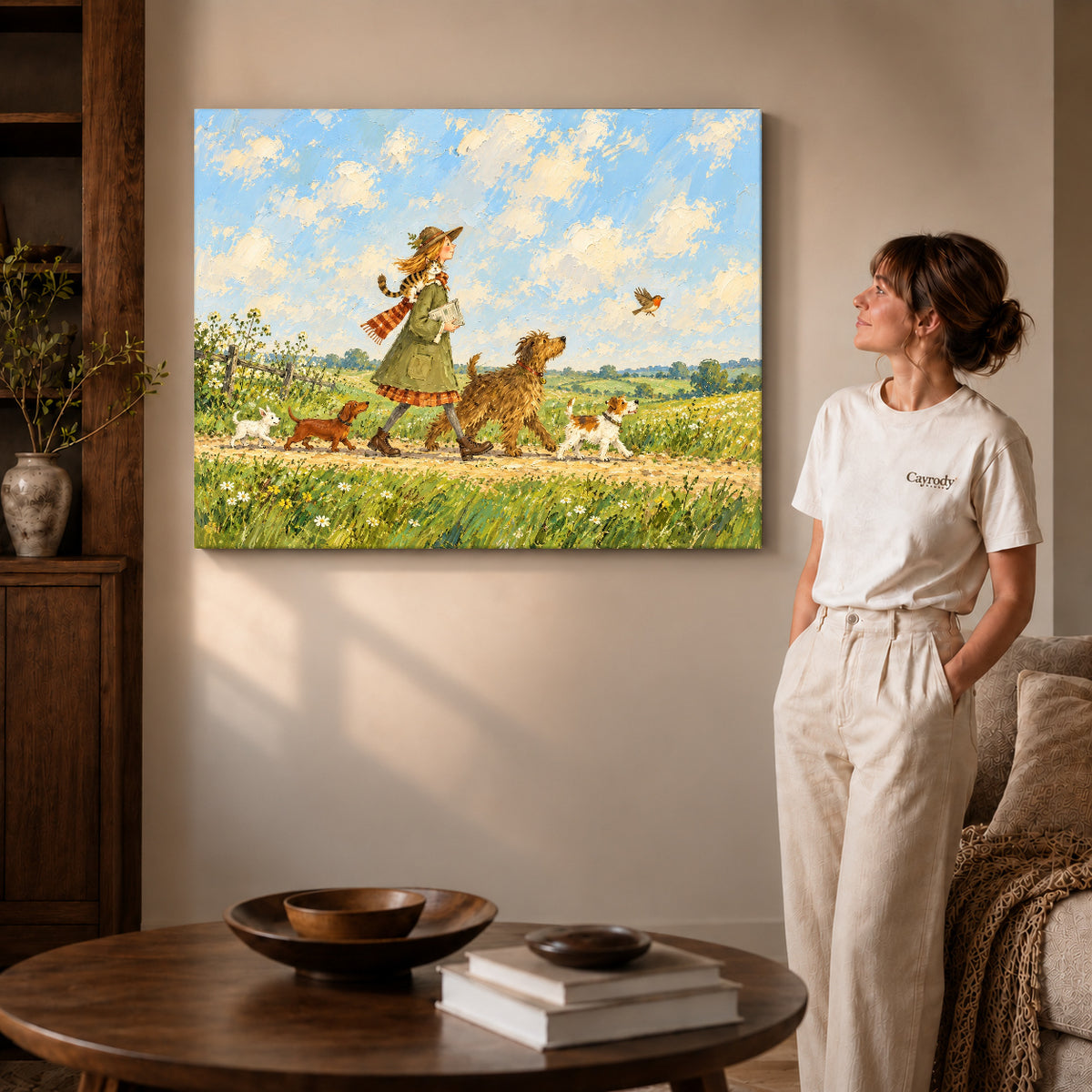 Gallery wrapped countryside dog walk artwork with shaded canvas edges beside a woman wearing cream clothing.