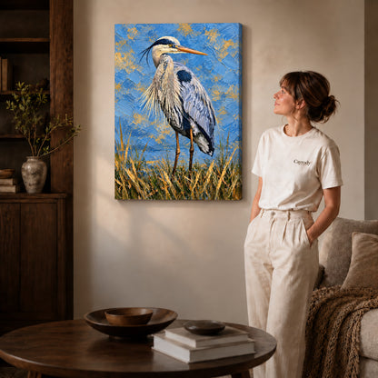 Gallery wrapped blue heron portrait artwork with shaded canvas edges beside a woman wearing cream clothing.