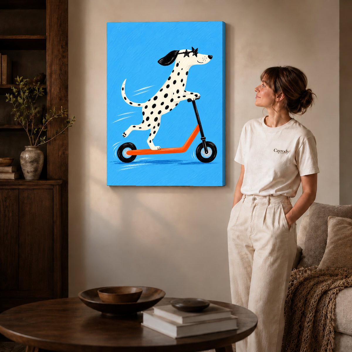Gallery wrapped scooter dalmatian artwork with shaded canvas edges beside a woman wearing cream clothing.