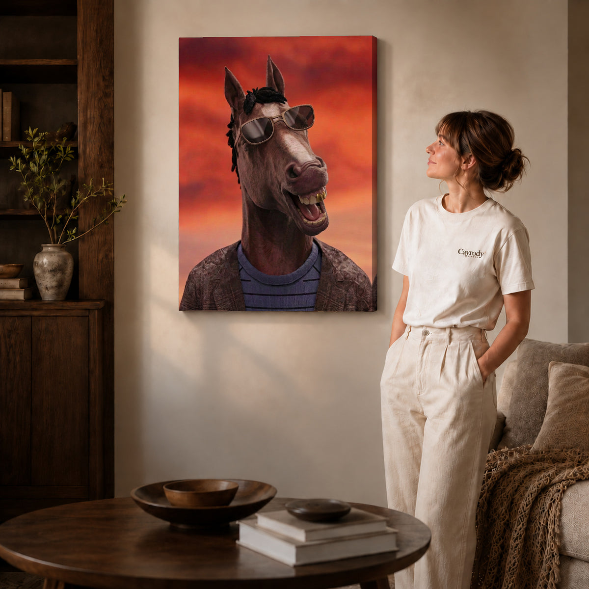 Gallery wrapped smiling shades horse artwork with shaded canvas edges beside a woman wearing cream clothing.