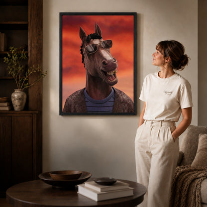 Black framed smiling shades horse artwork beside a woman in a warm neutral living room.