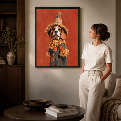 Black framed scarecrow spaniel artwork beside a woman in a warm neutral living room.