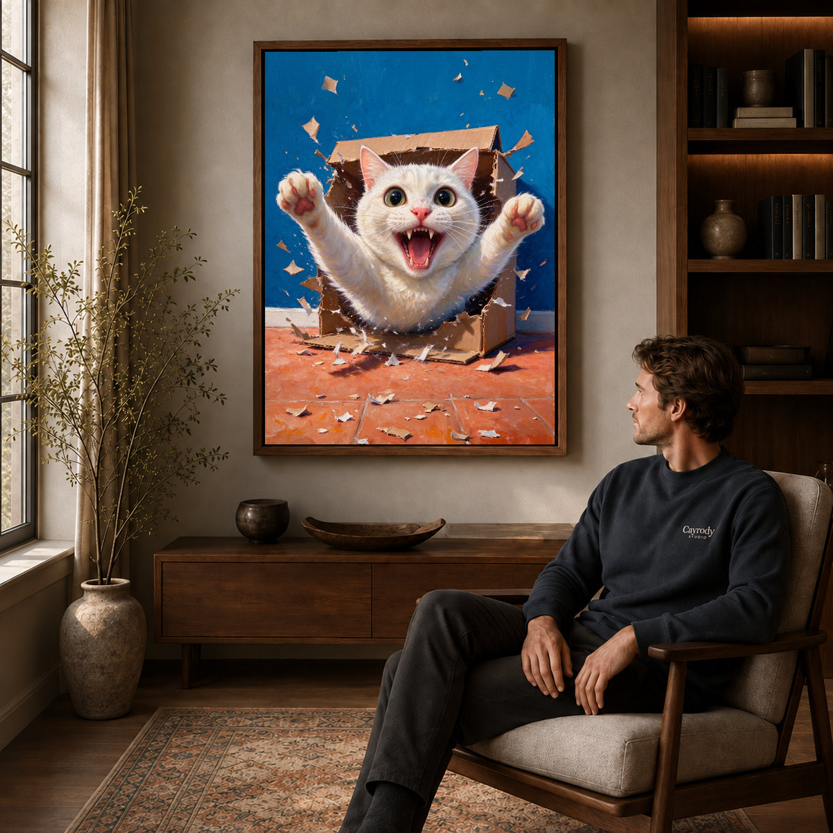 Walnut framed surprise box kitten artwork above a seated man in a wood furnished living room.