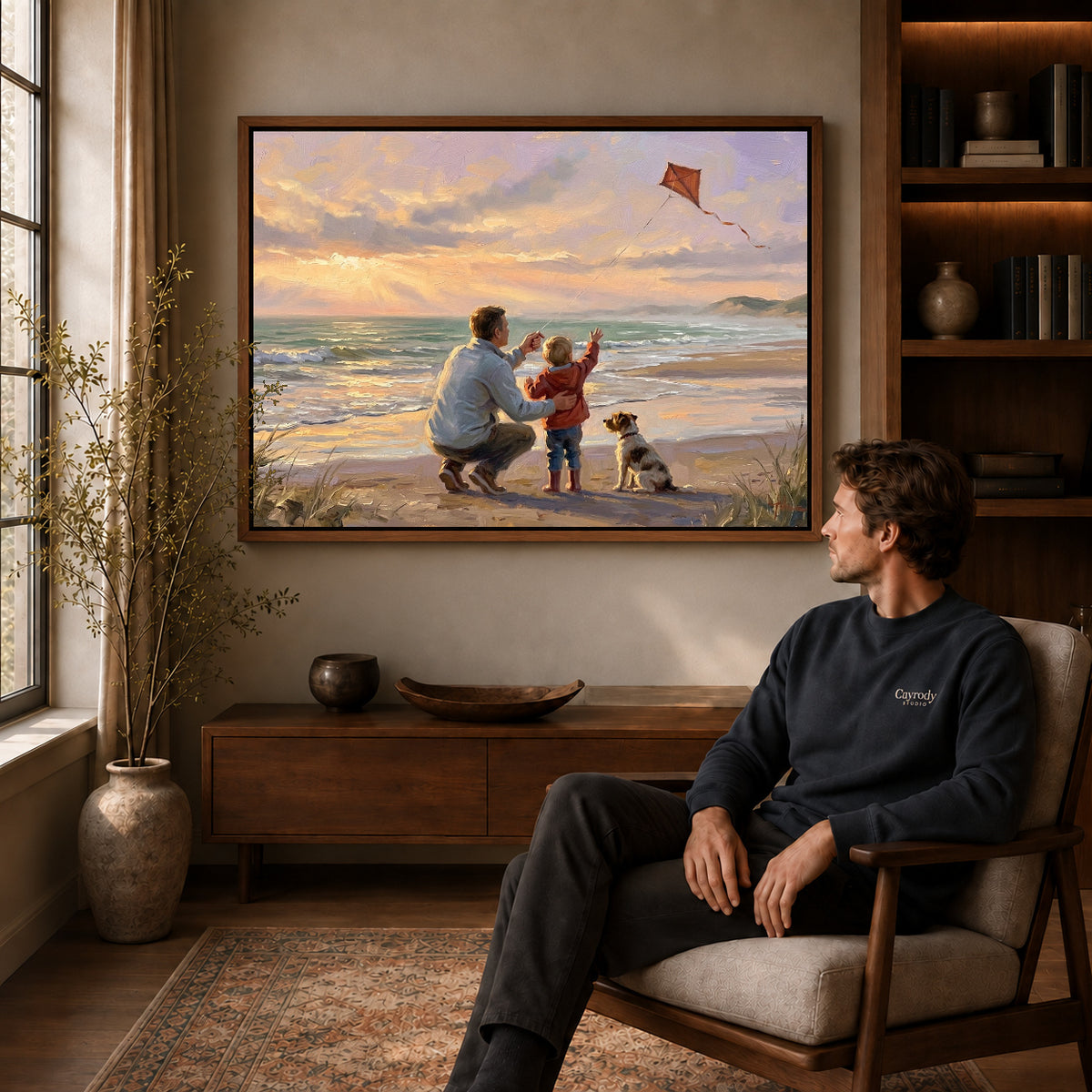 Walnut framed family beach kite artwork above a seated man in a wood furnished living room.