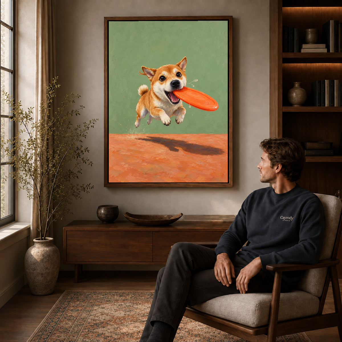 Walnut framed flying disc puppy artwork above a seated man in a wood furnished living room.