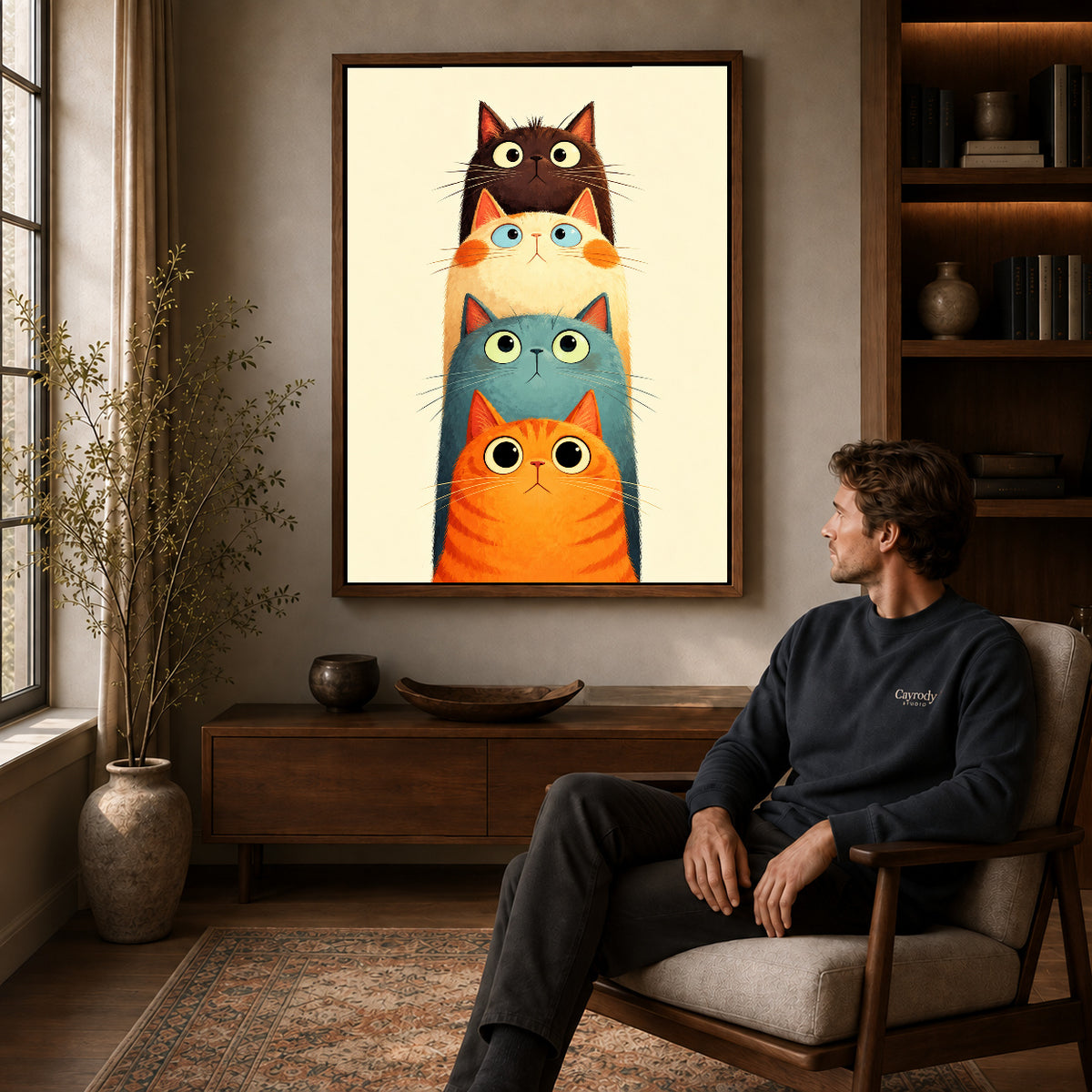 Walnut framed stacked curious cats artwork above a seated man in a wood furnished living room.