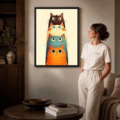 Black framed stacked curious cats artwork beside a woman in a warm neutral living room.