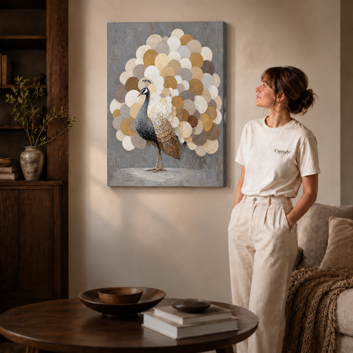 Gallery wrapped neutral peacock fan artwork with shaded canvas edges beside a woman wearing cream clothing.