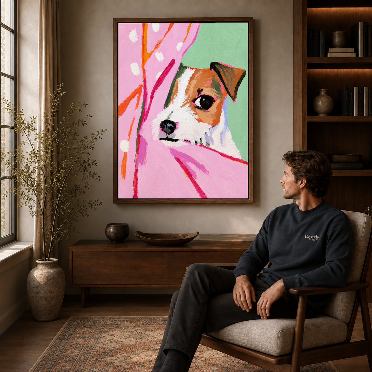 Walnut framed pink curtain puppy artwork above a seated man in a wood furnished living room.
