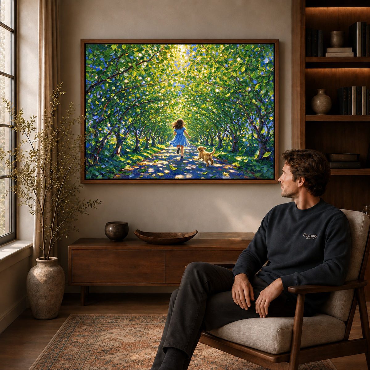 Walnut framed sunlit woodland run artwork above a seated man in a wood furnished living room.