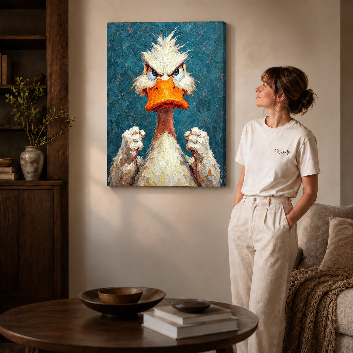 Gallery wrapped feisty duck portrait artwork with shaded canvas edges beside a woman wearing cream clothing.