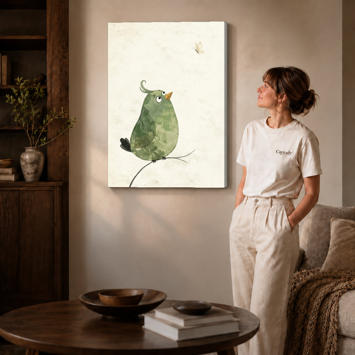 Gallery wrapped butterfly watching bird artwork with shaded canvas edges beside a woman wearing cream clothing.