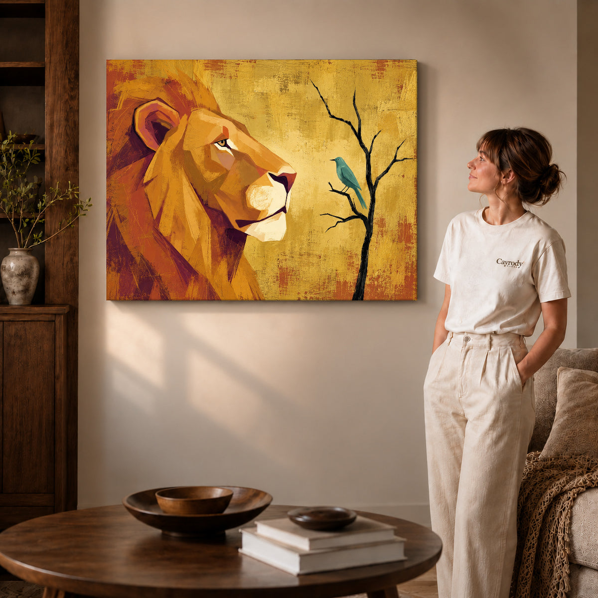 Gallery wrapped lion bird encounter artwork with shaded canvas edges beside a woman wearing cream clothing.