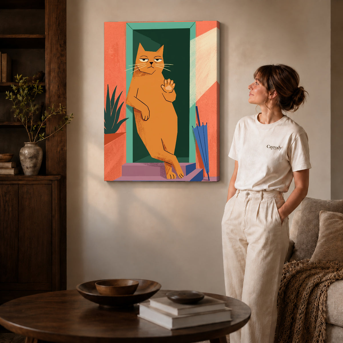 Gallery wrapped doorway greeting cat artwork with shaded canvas edges beside a woman wearing cream clothing.
