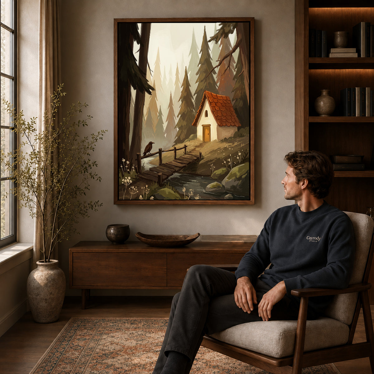 Walnut framed quiet forest cottage artwork above a seated man in a wood furnished living room.