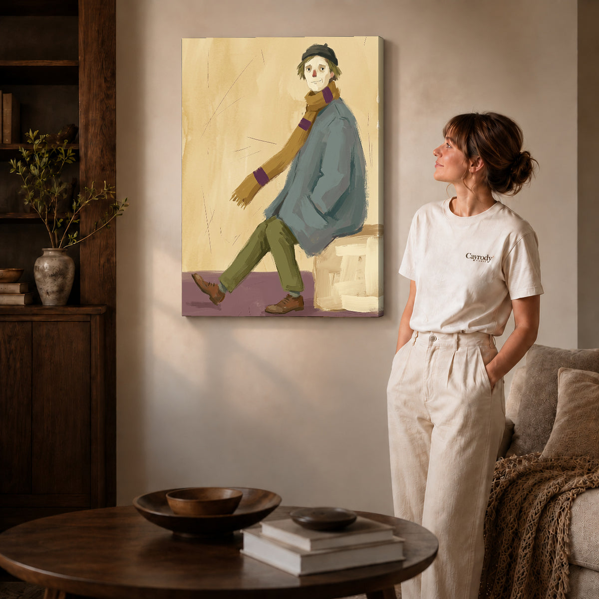 Gallery wrapped quiet scarf wanderer artwork with shaded canvas edges beside a woman wearing cream clothing.