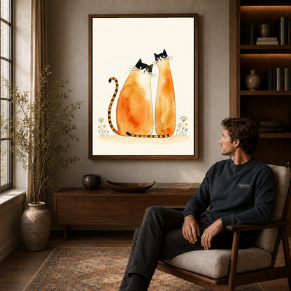 Walnut framed watercolor cat pair artwork above a seated man in a wood furnished living room.