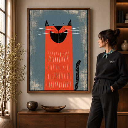 Grinning Red Cat artwork in a walnut frame beside a standing woman in a warm room.