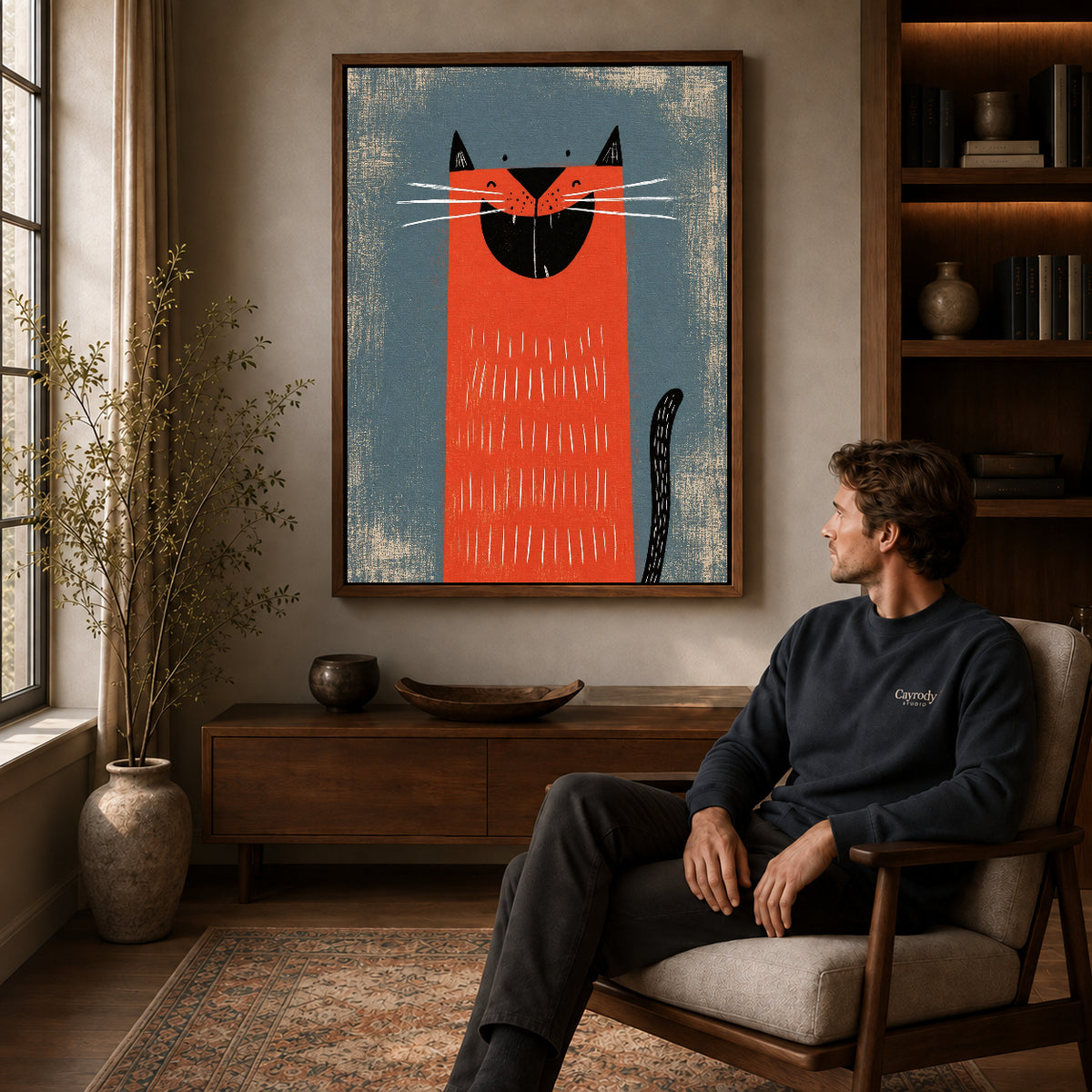 Walnut framed grinning red cat artwork above a seated man in a wood furnished living room.