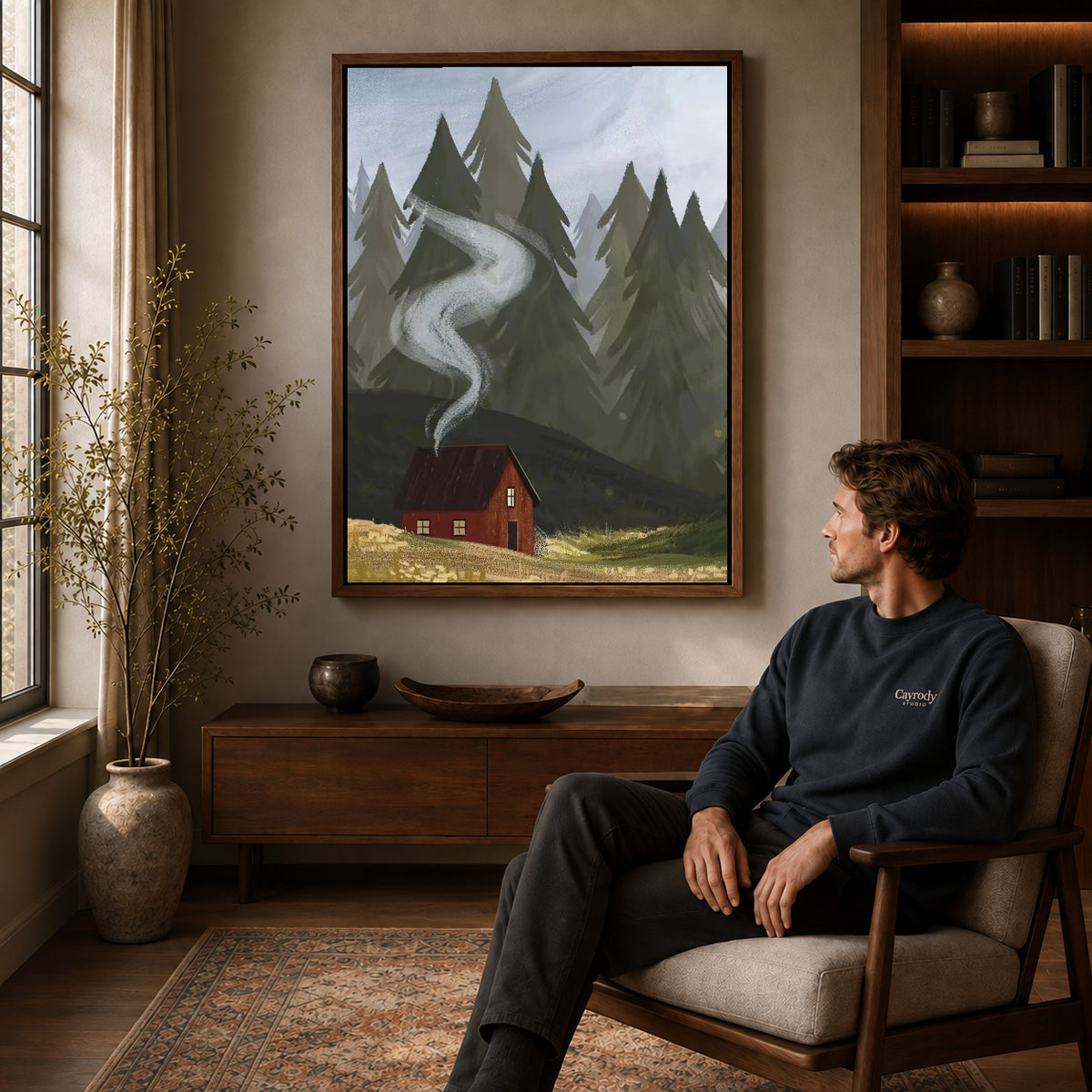 Walnut framed forest cabin smoke artwork above a seated man in a wood furnished living room.