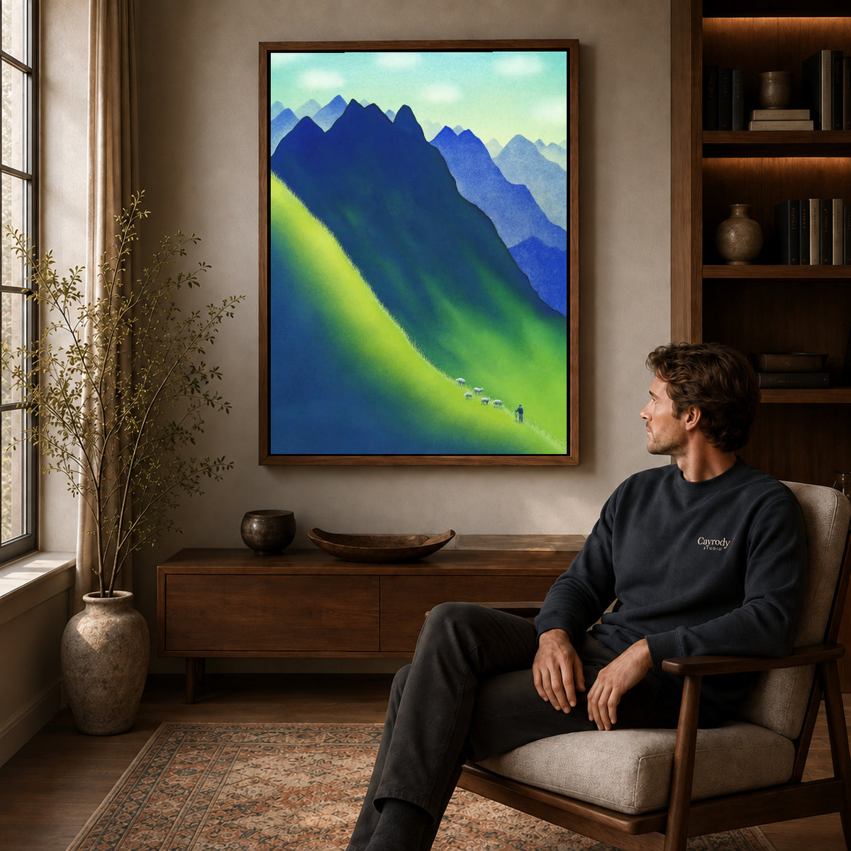 Walnut framed blue mountain canvas art displayed above a seated man in a wood furnished living room.
